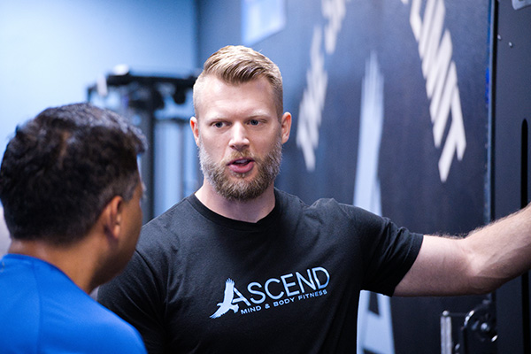 Jesse speaking to a student who has his back to the camera