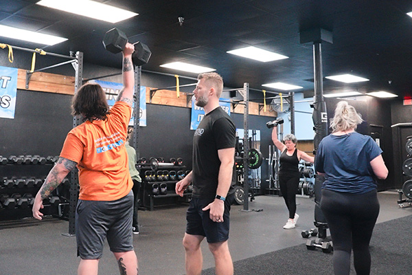 People with different fitness levels working out at gym facility