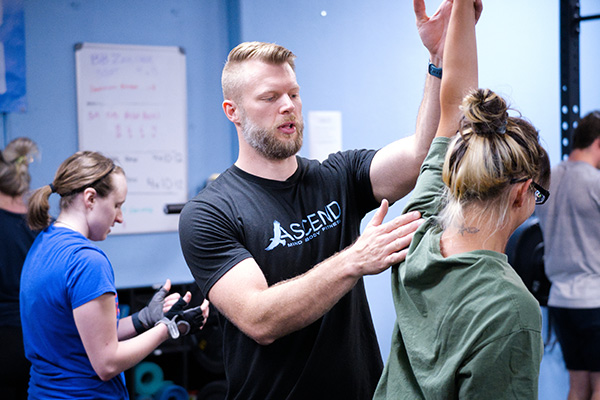 Coach Jesse giving a student feedback on proper form