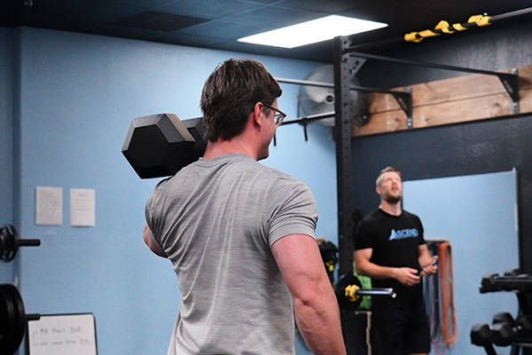 Adult male lifting weights at the gym